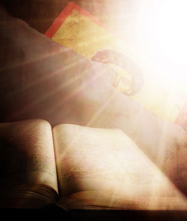 17900523 - abstract holly light over the human hand and bible